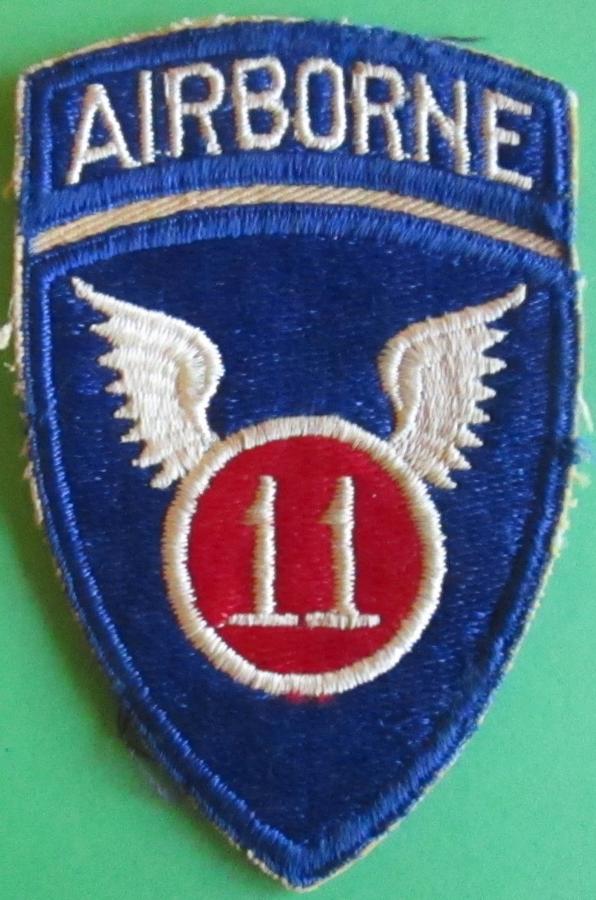 A WWII PERIOD US 11TH AIRBORNE FORCES 1 PEACE ARM BADGE