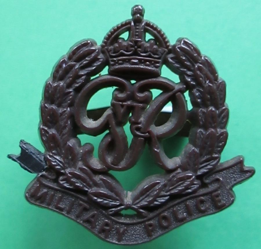 A WWII PLASTIC MILITARY POLICE CAP BADGE