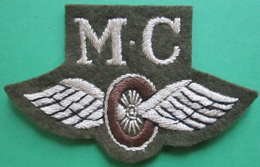 A WWII MOTOR CYCLIST WINGS AND WHEEL TRADE BADGE