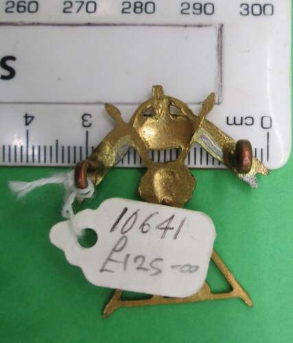 A RARE OFFICERS SILVER AND GILT 27TH LANCERS CAP BADGE