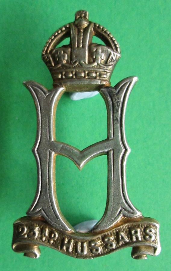 A 23rd HUSSARS SILVER AND GILT CAP BADGE