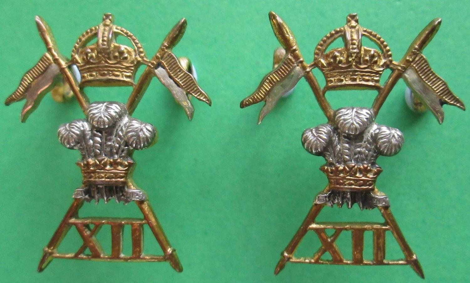 A MATCHING PAIR OF 12th LANCERS OFFICERS SILVER AND GILT COLLAR BADGES