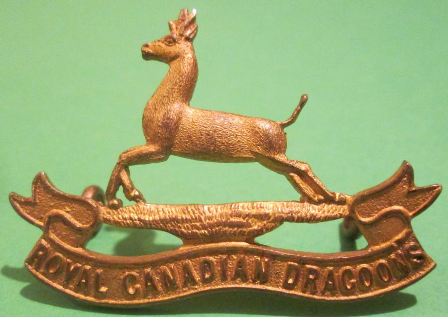 A ROYAL CANADIAN DRAGOONS GILT CAP BADGE
