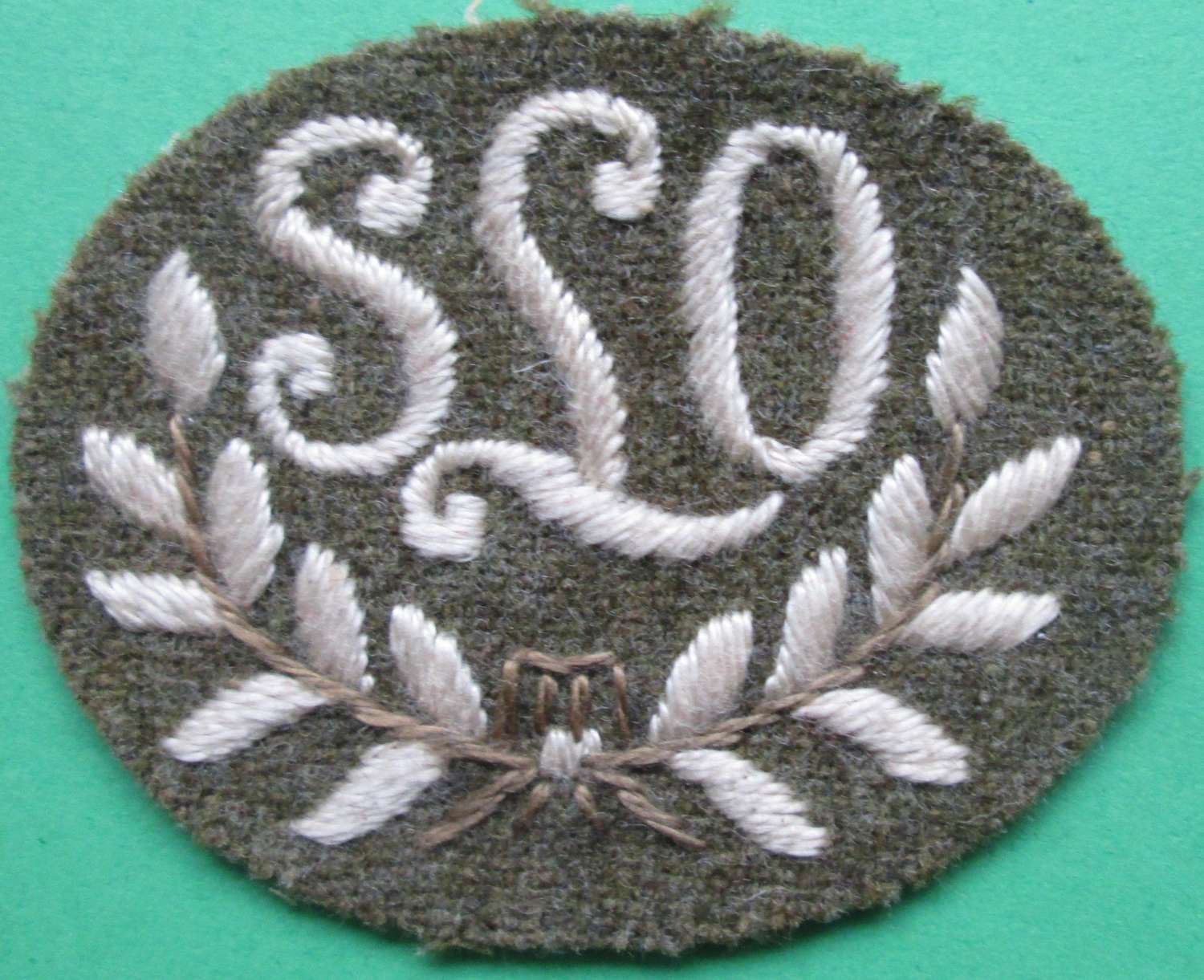 A WWII SEARCHLIGHT OPERATOR ARM BADGE SLO IN A WREATH