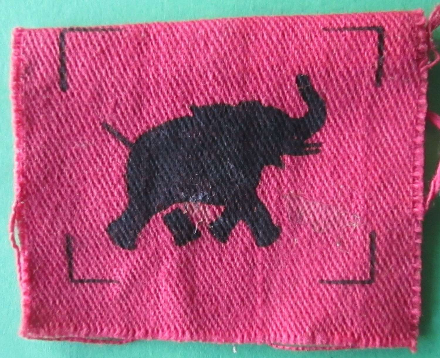 A IV CORPS FORMATION SIGN OF THE BLACK ELEPHANT ON A RED RECTANGLE
