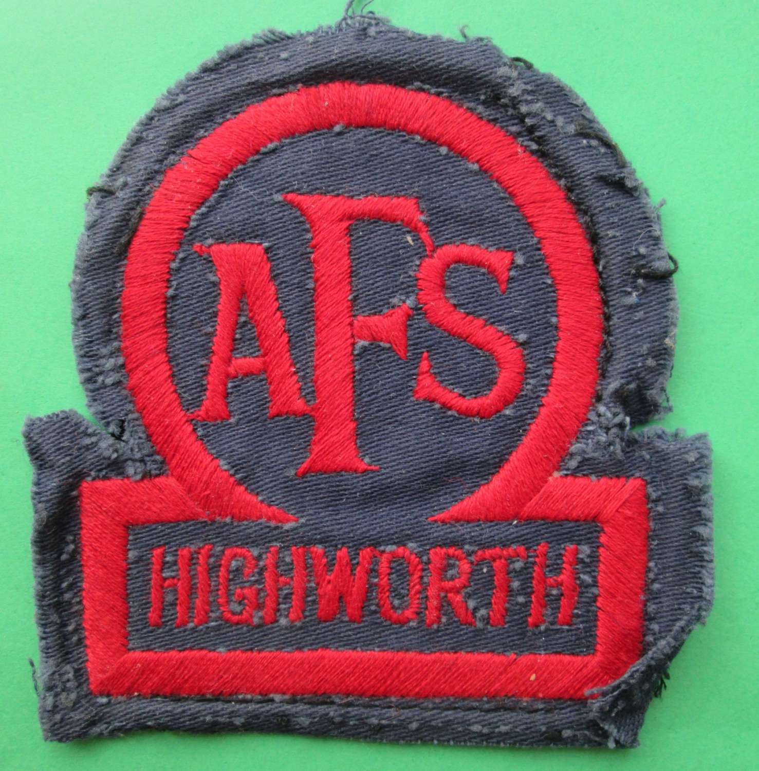 AN AUXILLARY FIRE SERVICE BADGE FOR HIGHWORTH