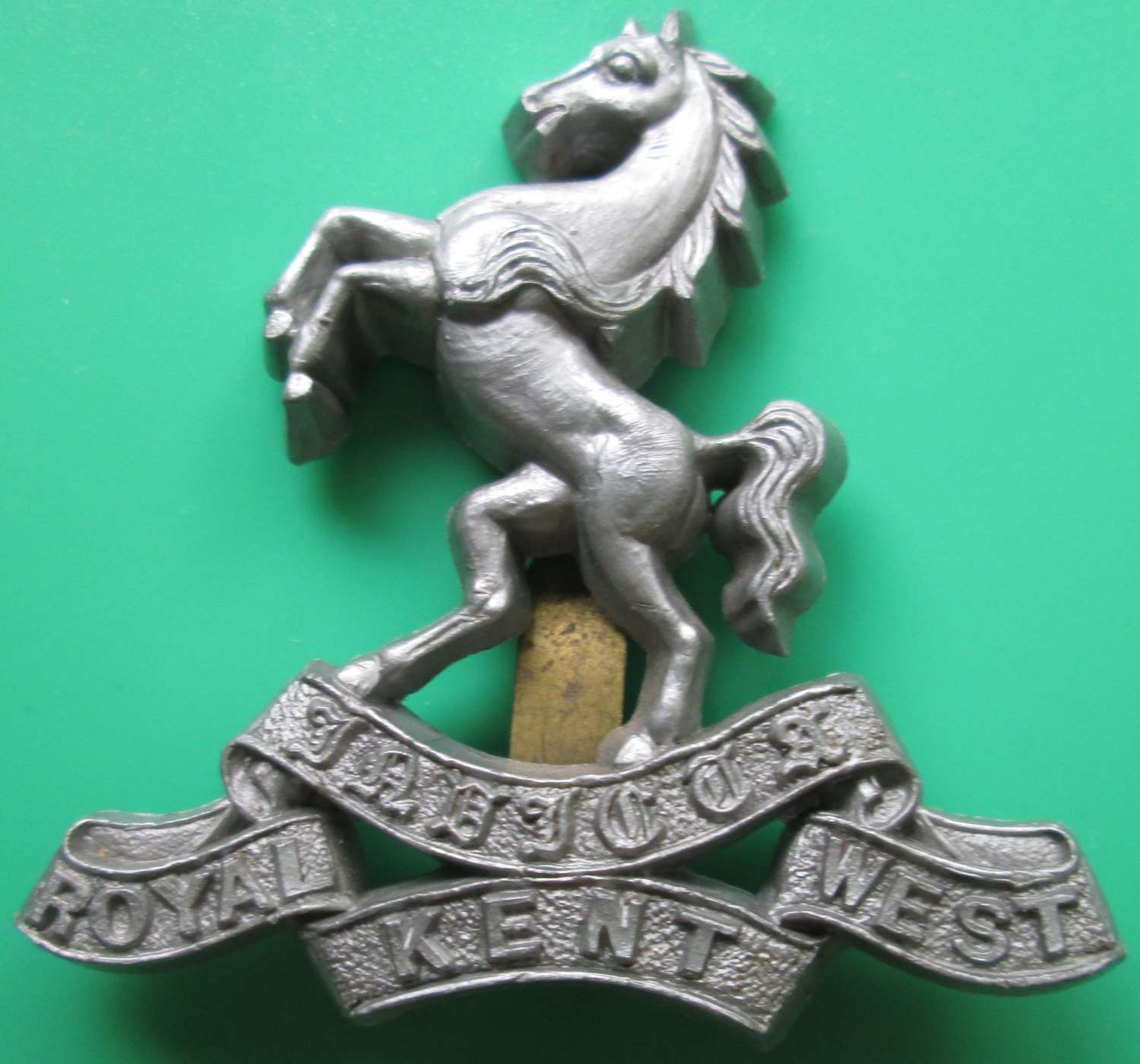 A WWII PERIOD ROYAL WEST KENT PLASTIC ECONOMY CAP BADGE
