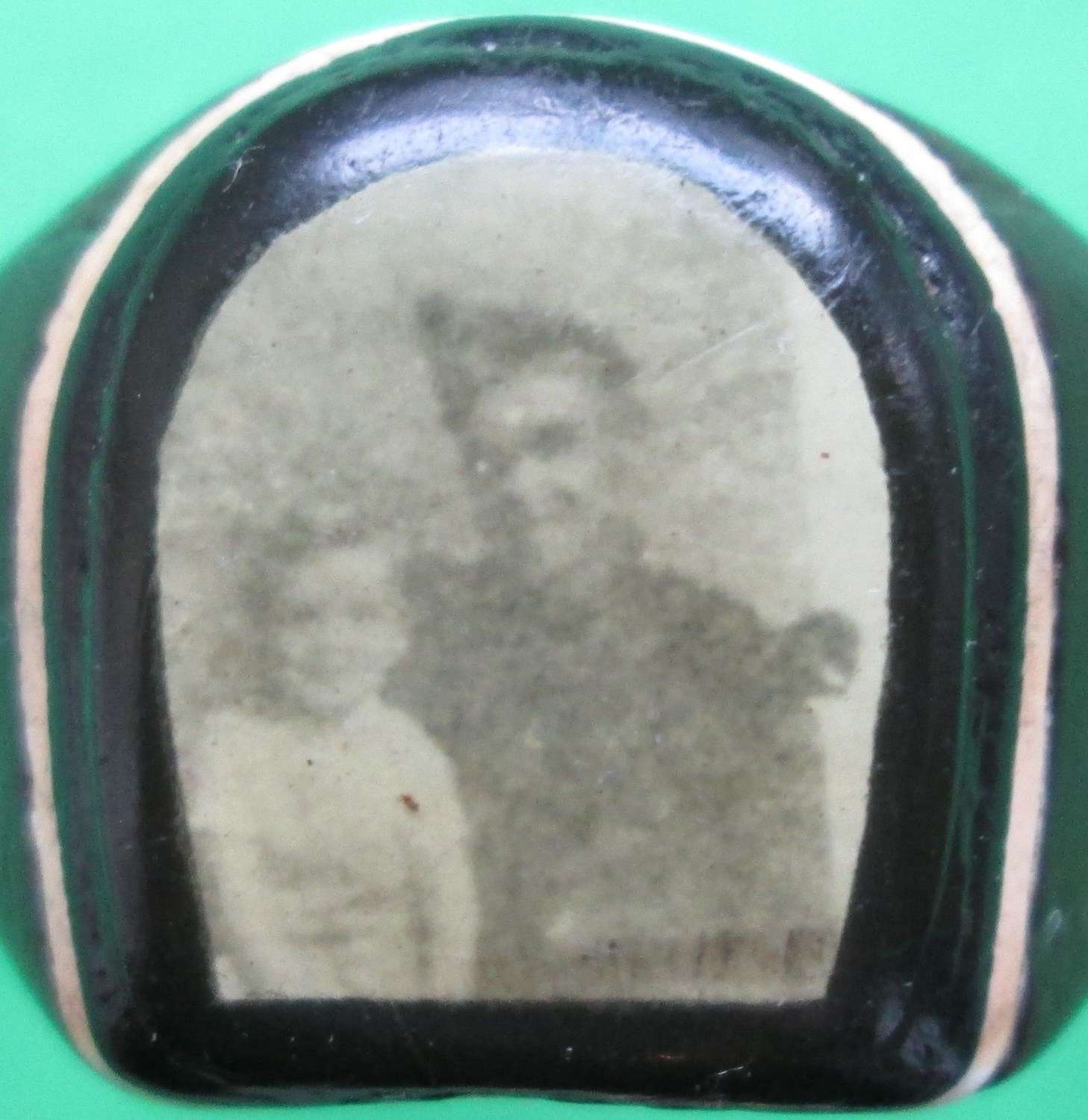 A WOODEN RING WHICH HAS A PHOTO TO THE CENTRE