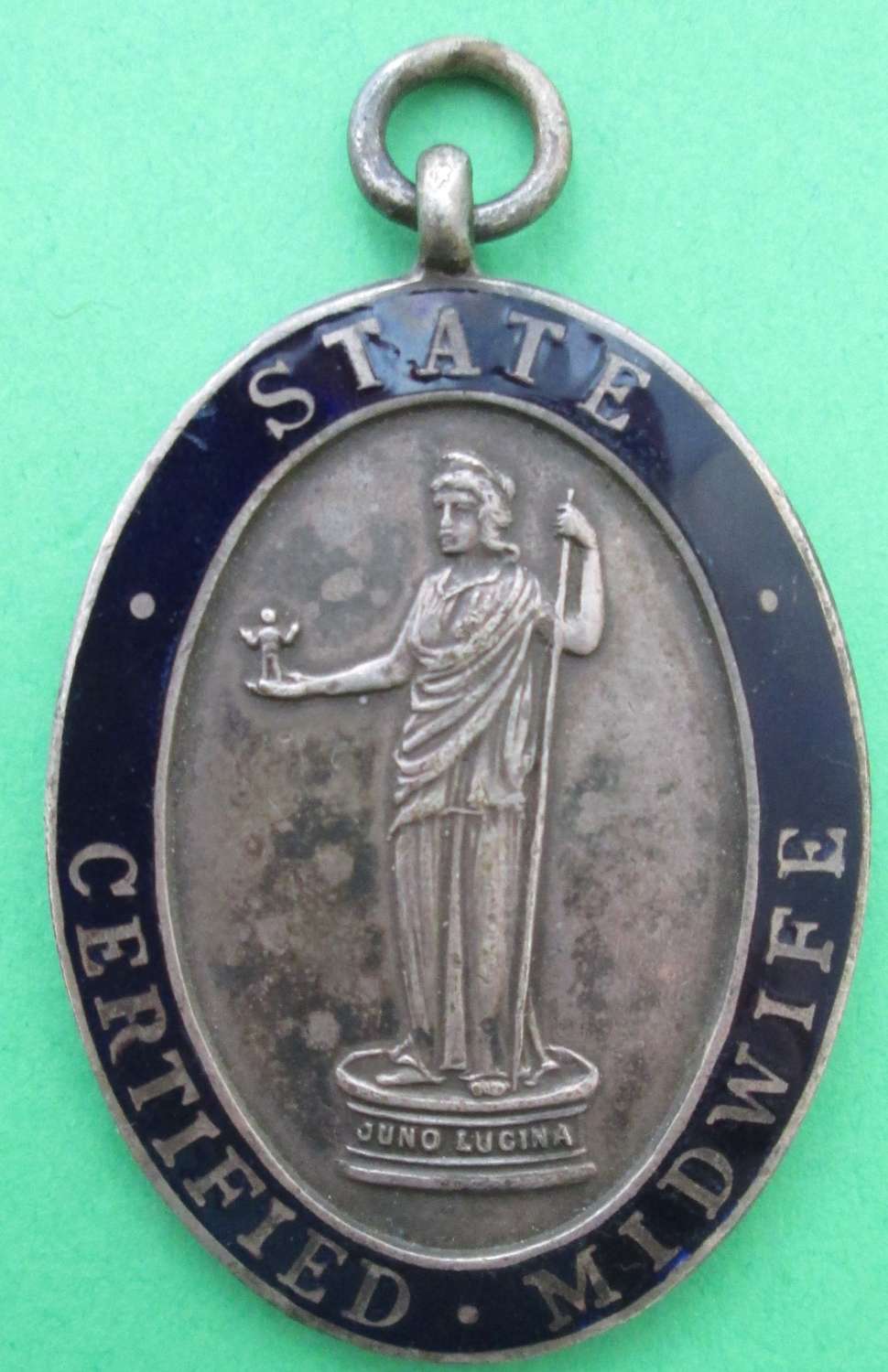 AN OVAL STATE CERTIFIED MIDWIFE'S PENDANT