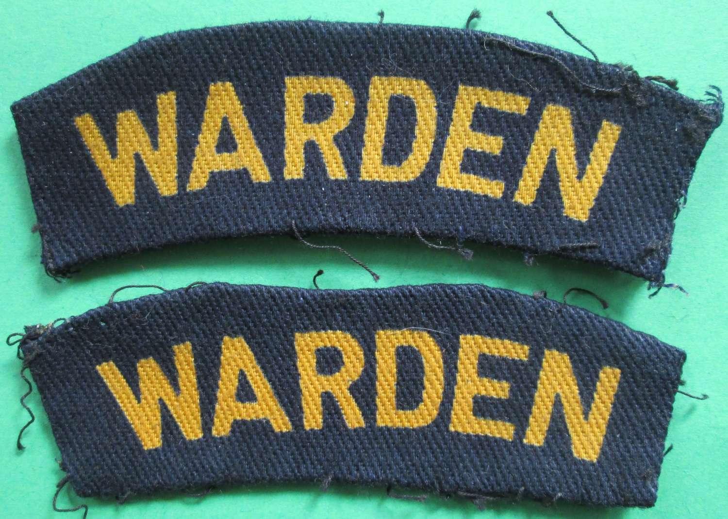 A PAIR OF HOME FRONT WARDEN WWII SHOULDER TITLES