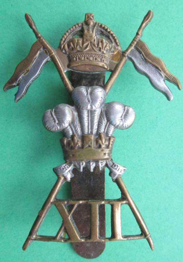 A WWII PERIOD CAP BADGE FOR THE 12th (PRINCE OF WALES) ROYAL LANCERS