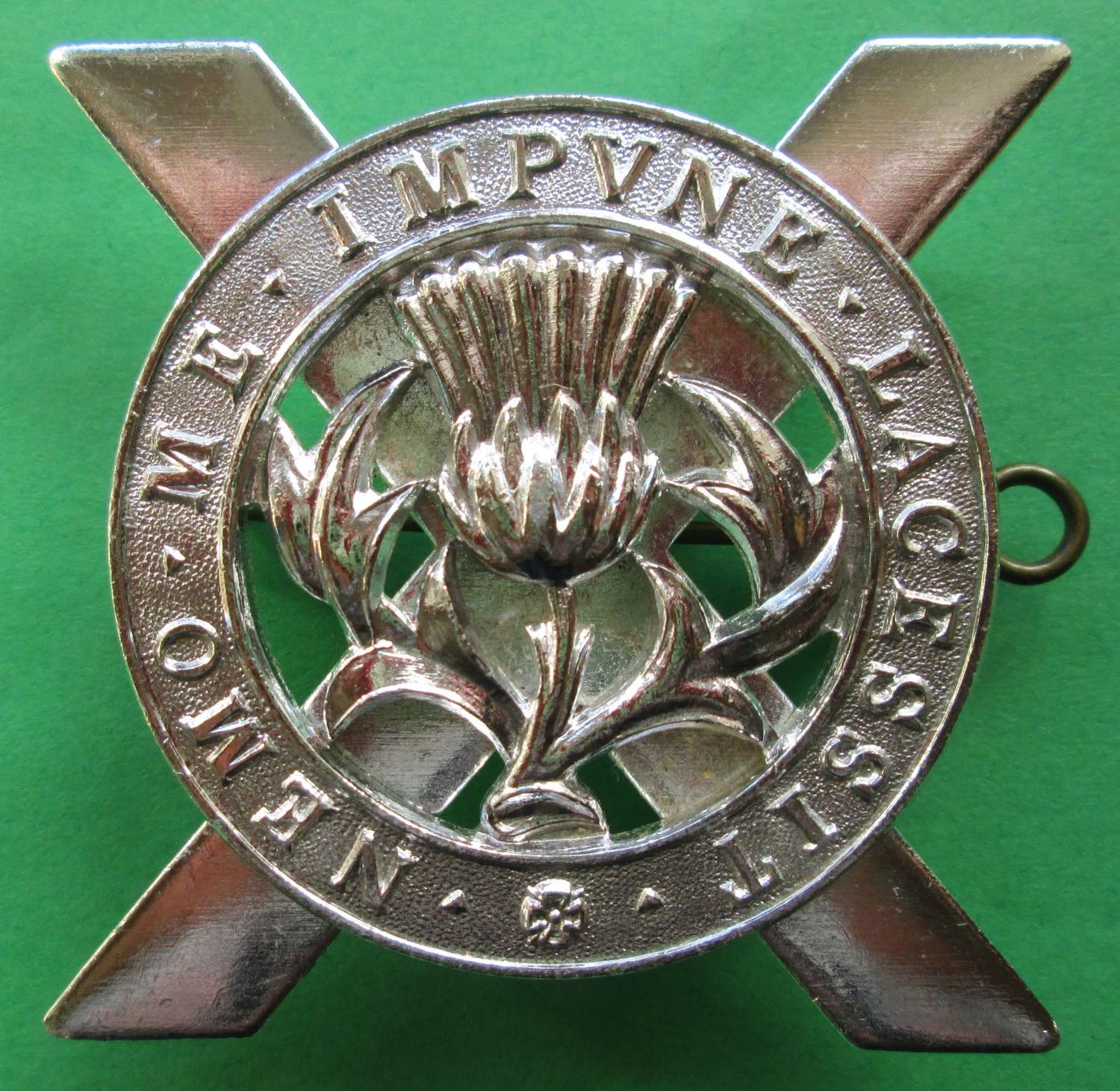 AN ANODISED CAP BADGE FOR THE LOWLAND BRIGADE