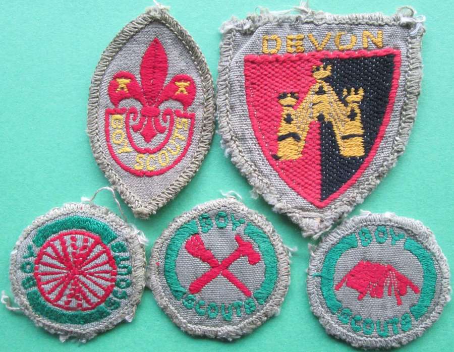 A group of early boy scout badges