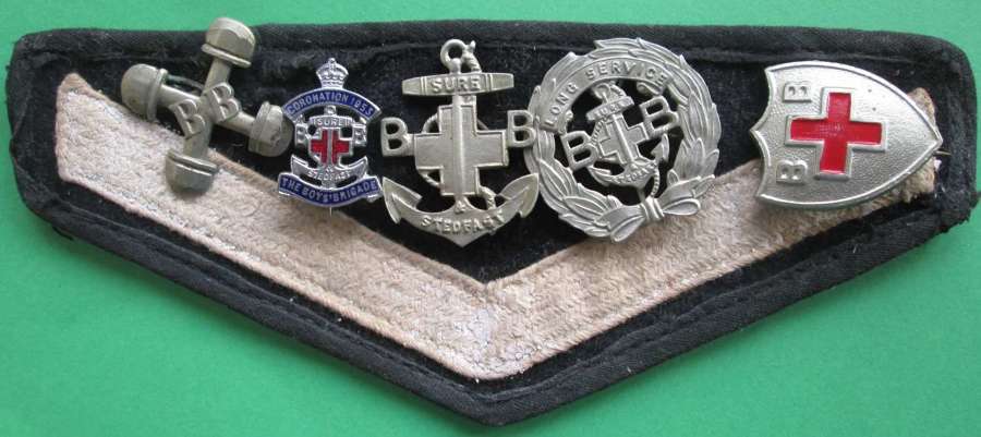 SELECTION OF BOYS BRIGADE BADGES ON A STRIPED ARM BAND