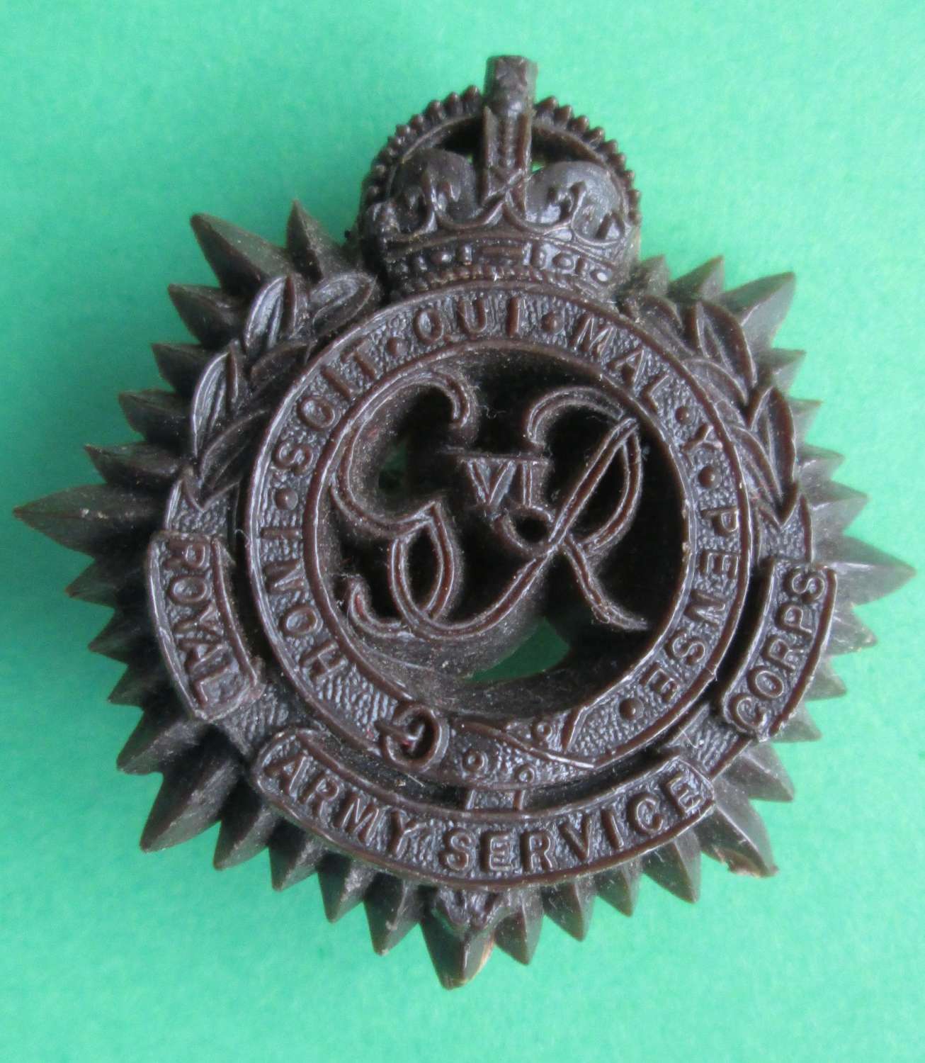 PLASTIC ROYAL ARMY SERVICE CORPS CAP BADGE