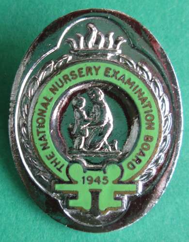 A VINTAGE PIN BADGE FOR THE NATIONAL NURSERY EXAMINATION BOARD