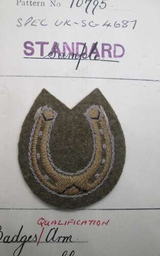 A horseshoe qualification badge on its Royal Army clothing department board dated 1938